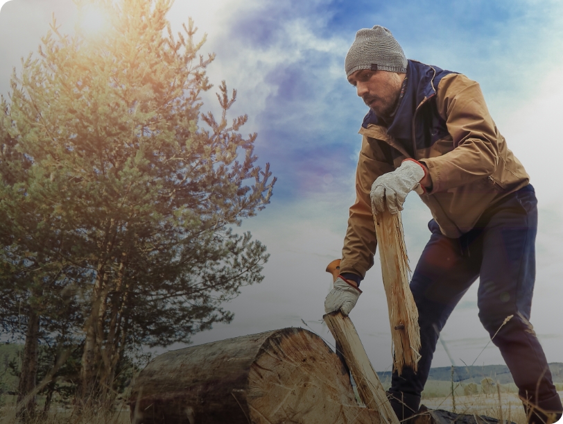 person chopping wood in winter workwear